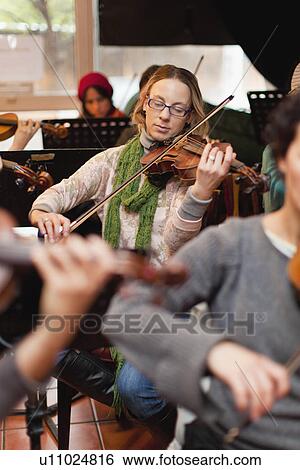 Violin player practicing with group View Large Photo Image Stock Photograph - Violin player practicing with group. Fotosearch