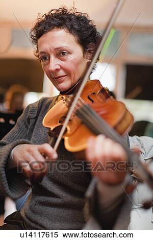 Stock Photography - Violin player practicing with group. Fotosearch