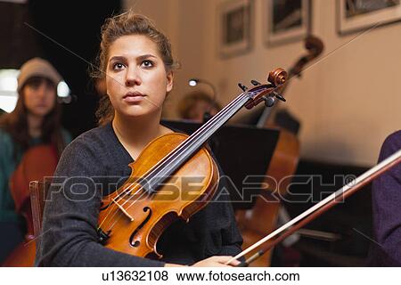 Violin player sitting in practice View Large Photo Image Stock Photo - Violin player sitting in practice. Fotosearch