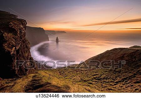 Stock Photograph - Waves crashing on rocky beach. Fotosearch
