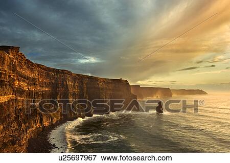 Waves crashing on rocky cliffs View Large Photo Image Stock Photo - Waves crashing on rocky cliffs. Fotosearch