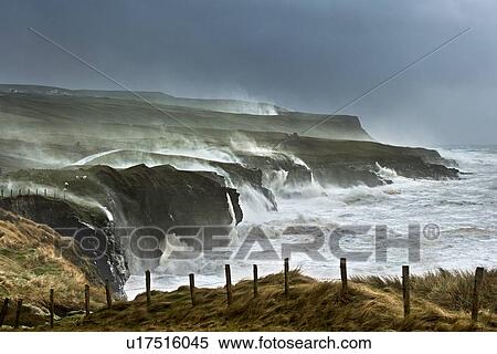 Stock Photography - Waves crashing on rocky cliffs. Fotosearch