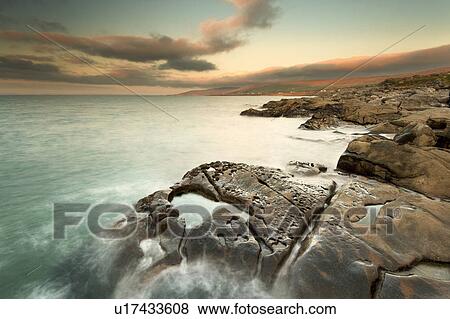Stock Photo - Waves washing up on rock formations. Fotosearch