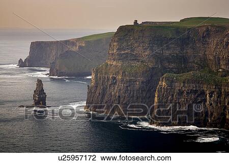 Waves washing up on rocky cliffs View Large Photo Image Stock Image - Waves washing up on rocky cliffs. Fotosearch