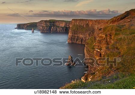 Waves washing up on rocky cliffs View Large Photo Image Stock Photo - Waves washing up on rocky cliffs. Fotosearch