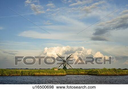 Stock Photo - Windmill in rural landscape. Fotosearch