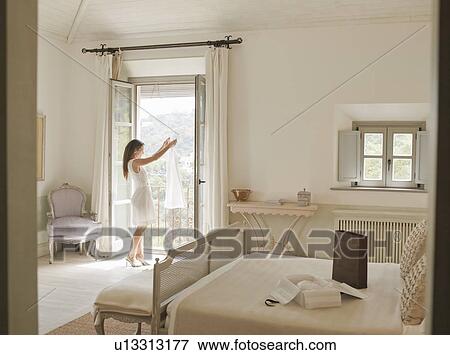 Woman admiring dress in window View Large Photo Image Stock Photo - Woman admiring dress in window. Fotosearch