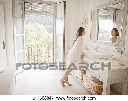 Woman admiring herself in mirror View Large Photo Image Stock Photo - Woman admiring herself in mirror. Fotosearch