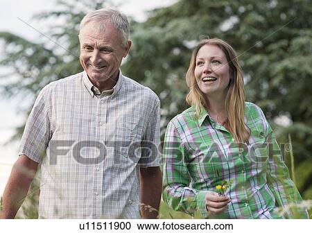 Woman and father walking outdoors View Large Photo Image Stock Image - Woman and father walking outdoors. Fotosearch