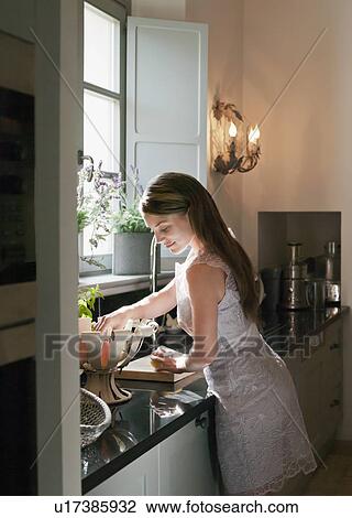 Woman cooking in kitchen View Large Photo Image Stock Image - Woman cooking in kitchen. Fotosearch