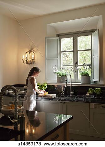 Woman cooking in kitchen View Large Photo Image Stock Photo - Woman cooking in kitchen. Fotosearch