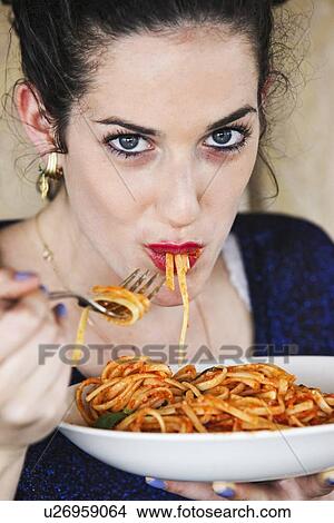 Woman eating plate of pasta View Large Photo Image Picture - Woman eating plate of pasta. Fotosearch