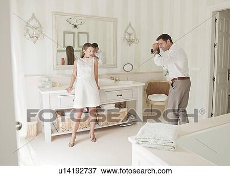Woman having picture taken in bathroom View Large Photo Image Stock Photo - Woman having picture taken in bathroom. Fotosearch