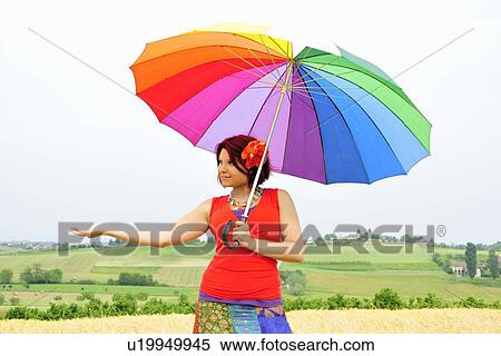 Stock Photography - Woman holding colorful umbrella. Fotosearch