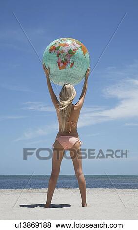 Woman holding globe on beach View Large Photo Image Stock Photo - Woman holding globe on beach. Fotosearch