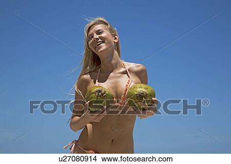 Woman in bikini holding tropical fruit View Large Photo Image Picture - Woman in bikini holding tropical fruit. Fotosearch