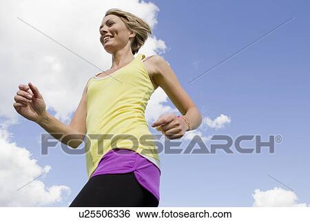 Woman jogging outdoors View Large Photo Image Stock Photograph - Woman jogging outdoors. Fotosearch