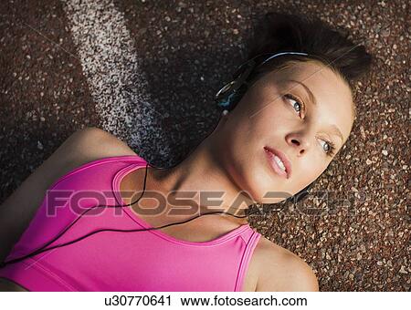 Stock Image - Woman laying on sidewalk. Fotosearch