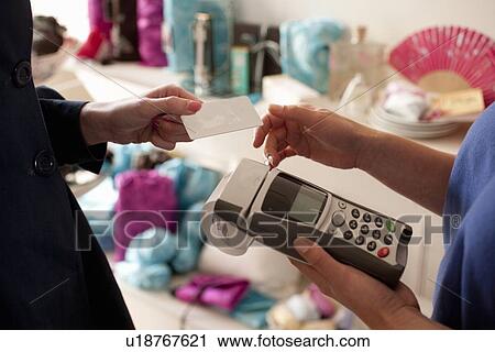 Woman paying with credit card in store View Large Photo Image Stock Image - Woman paying with credit card in store. Fotosearch