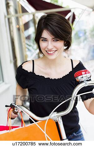 Woman pushing bicycle with shopping View Large Photo Image Stock Photography - Woman pushing bicycle with shopping. Fotosearch