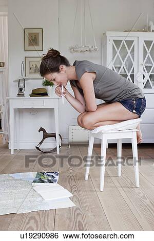 Woman reading maps on floor View Large Photo Image Stock Photograph - Woman reading maps on floor. Fotosearch