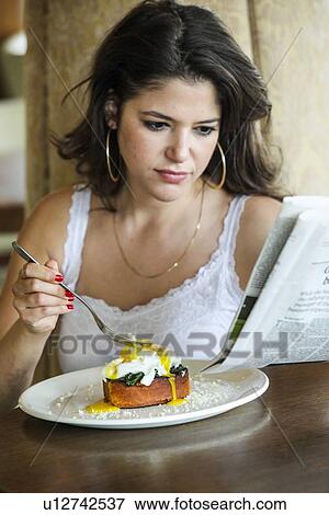 Woman reading newspaper at breakfast View Large Photo Image Stock Photo - Woman reading newspaper at breakfast. Fotosearch