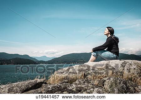 Woman relaxing by rural lake View Large Photo Image Stock Photo - Woman relaxing by rural lake. Fotosearch