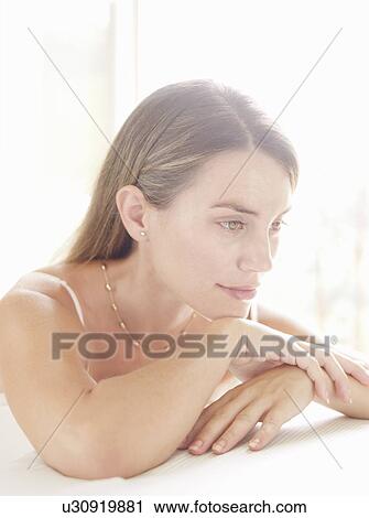 Woman resting chin on hands View Large Photo Image Stock Image - Woman resting chin on hands. Fotosearch