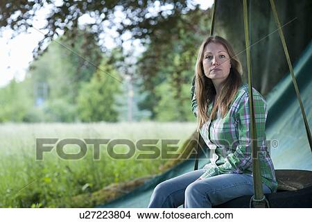 Woman sitting in tire swing outdoors View Large Photo Image Picture - Woman sitting in tire swing outdoors. Fotosearch