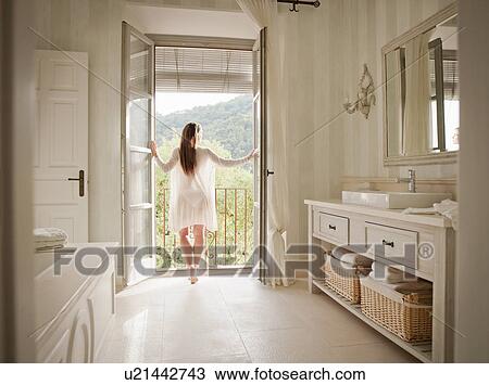 Woman standing at bathroom balcony View Large Photo Image Stock Image - Woman standing at bathroom balcony. Fotosearch