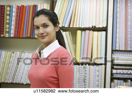 Woman standing in fabric shop View Large Photo Image Stock Image - Woman standing in fabric shop. Fotosearch
