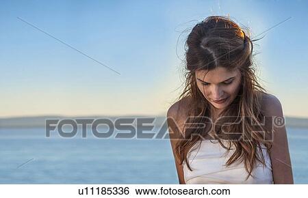 Woman standing on beach View Large Photo Image Stock Photograph - Woman standing on beach. Fotosearch