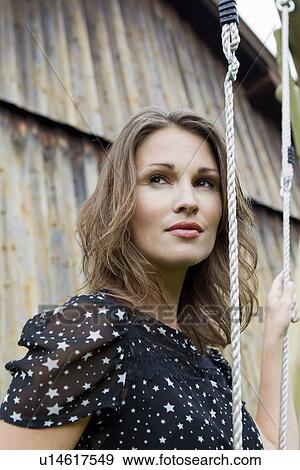Stock Photo - Woman standing outdoors. Fotosearch