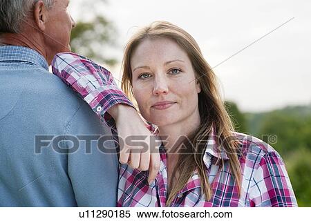Stock Photography - Woman standing with father outdoors. Fotosearch