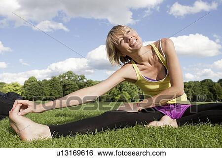 Stock Photograph - Woman stretching outdoors. Fotosearch