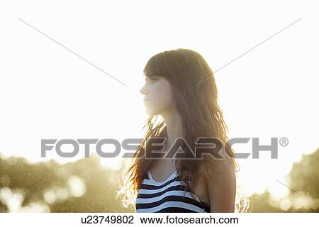 Stock Image - Woman walking outdoors. Fotosearch