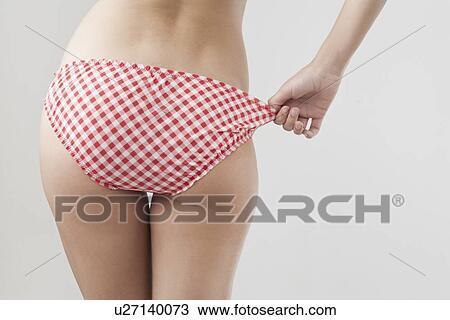 Stock Image - Woman wearing patterned underwear. Fotosearch