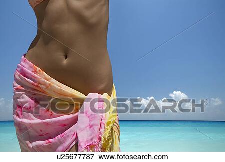 Woman wearing sarong on beach View Large Photo Image Stock Photo - Woman wearing sarong on beach. Fotosearch