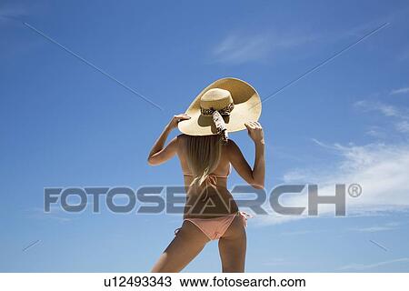 Stock Image - Woman wearing sunhat and bikini. Fotosearch