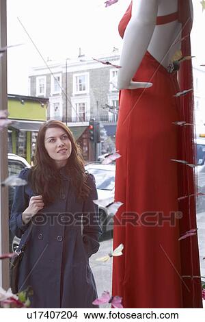 Woman window shopping on city street View Large Photo Image Picture - Woman window shopping on city street. Fotosearch