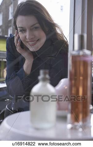 Stock Image - Woman window shopping on city street. Fotosearch