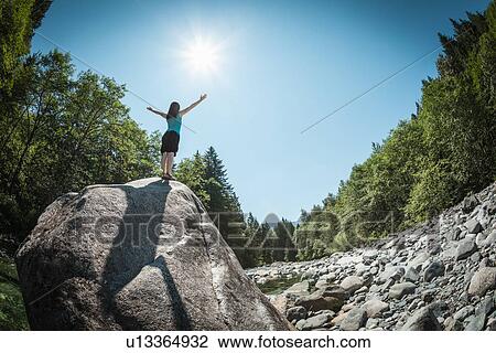 Woman with arms outstretched on rock View Large Photo Image Stock Image - Woman with arms outstretched on rock. Fotosearch