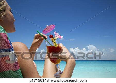 Woman with tropical drink on beach View Large Photo Image Stock Photo - Woman with tropical drink on beach. Fotosearch