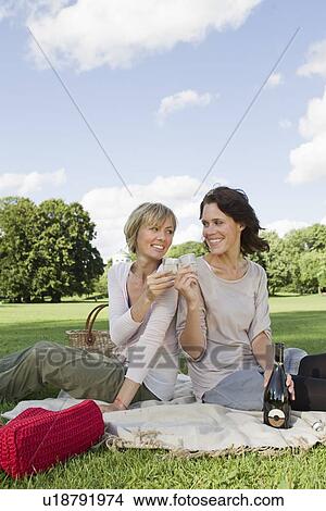 Women drinking champagne at picnic View Large Photo Image Picture - Women drinking champagne at picnic. Fotosearch
