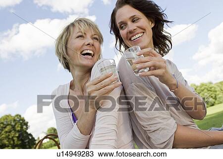 Women drinking champagne outdoors View Large Photo Image Stock Image - Women drinking champagne outdoors. Fotosearch