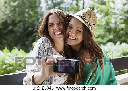 Women taking picture of themselves View Large Photo Image Stock Photography - Women taking picture of themselves. Fotosearch
