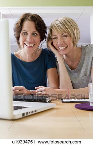 Women using laptop together View Large Photo Image Stock Image - Women using laptop together. Fotosearch