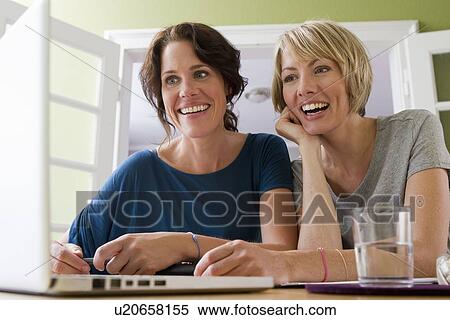 Women using laptop together View Large Photo Image Stock Photography - Women using laptop together. Fotosearch