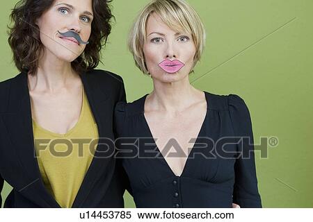 Stock Photography - Women wearing fake lips and mustache. Fotosearch