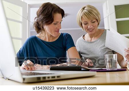 Women working together on laptop View Large Photo Image Stock Image - Women working together on laptop. Fotosearch